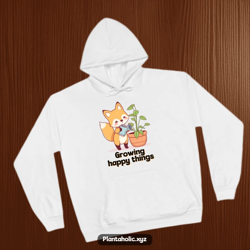 Funny hoodie with a happy fox holding a tiny watering can, tending a large potted plant, cozy and cheerful woodland apparel.